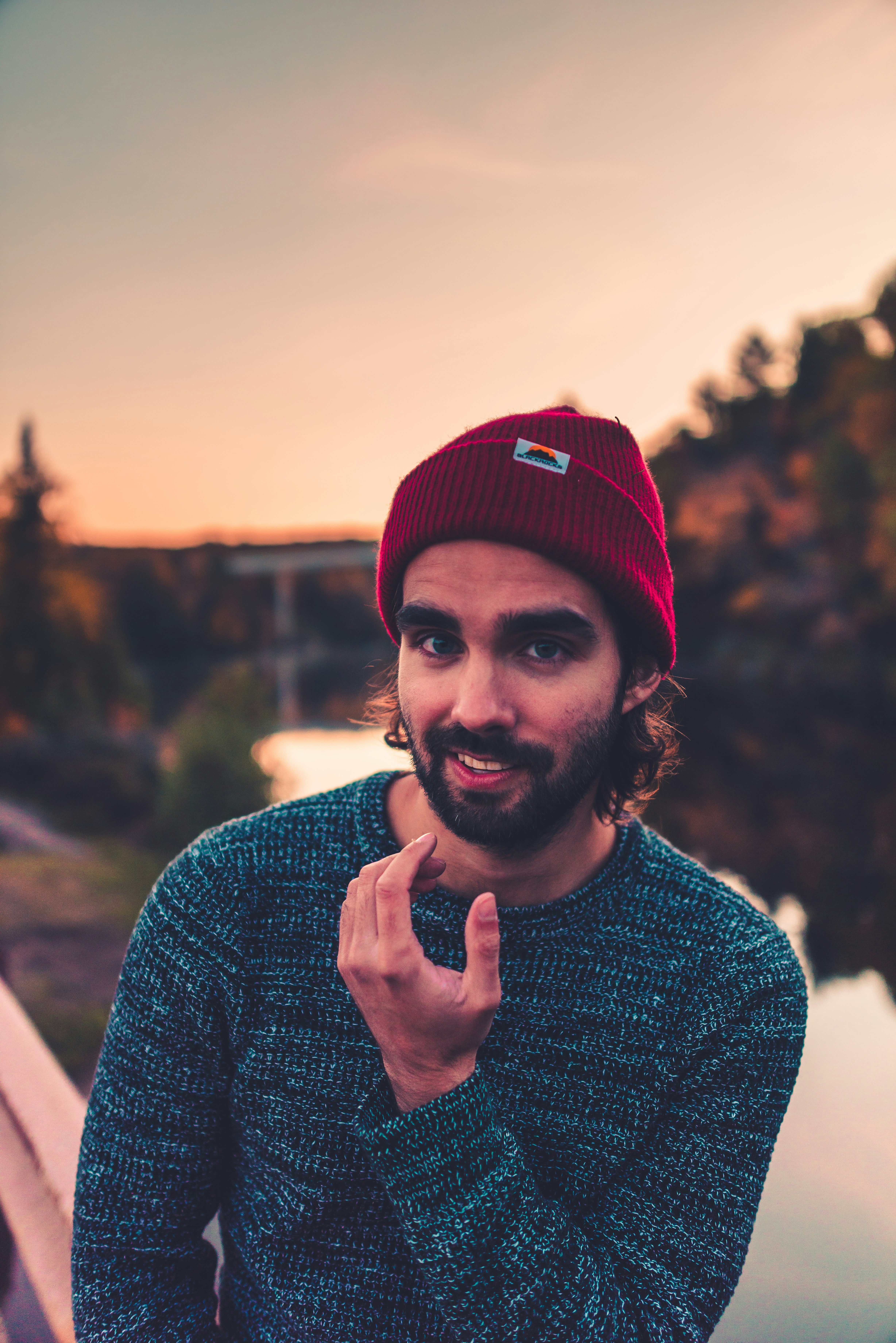 man in red knit cap and gray sweater